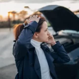 What if you're not at-fault for a rental car accident? A woman talking with her insurance company on the phone.