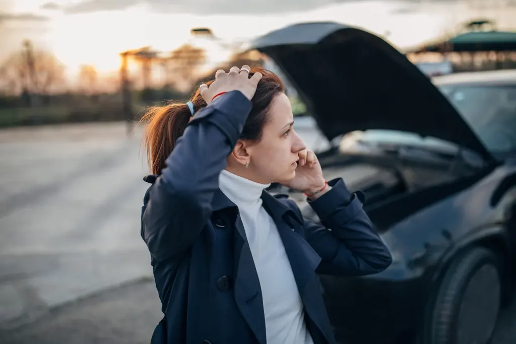 What if you're not at-fault for a rental car accident? A woman talking with her insurance company on the phone.