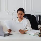 Woman at her office reviewing papers