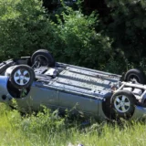 A car rollover accident by the side of the road
