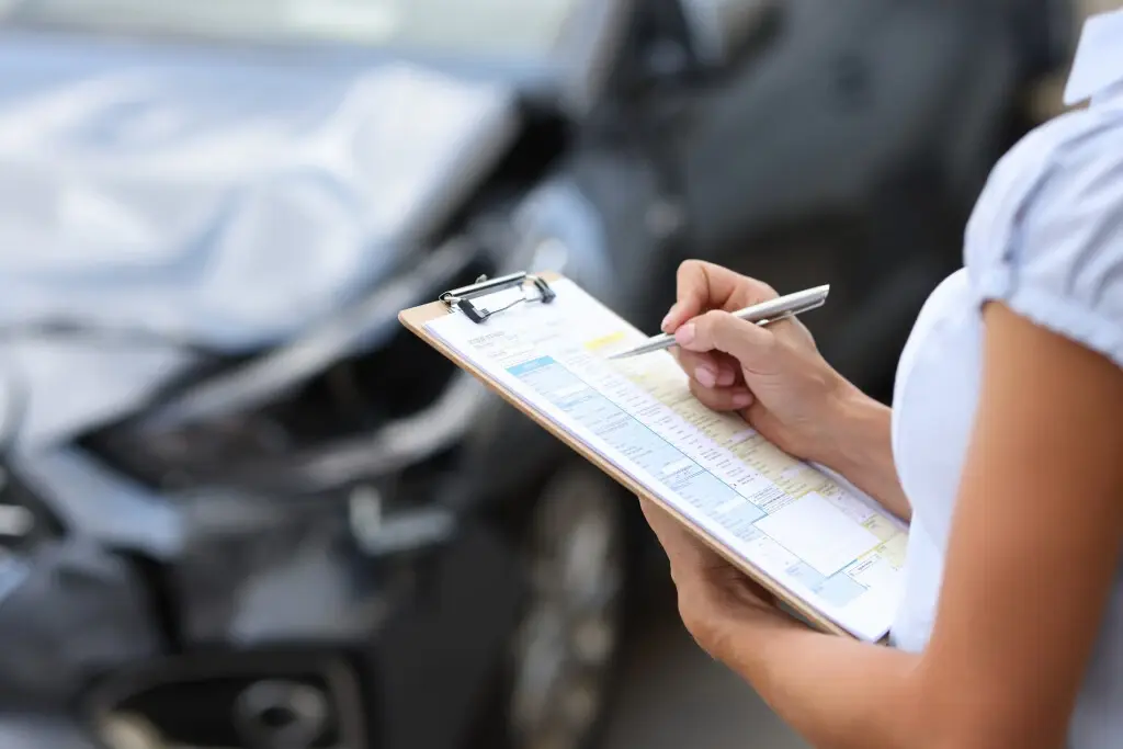 Do insurance companies go after uninsured drivers? An insurance agent inspecting a car accident.