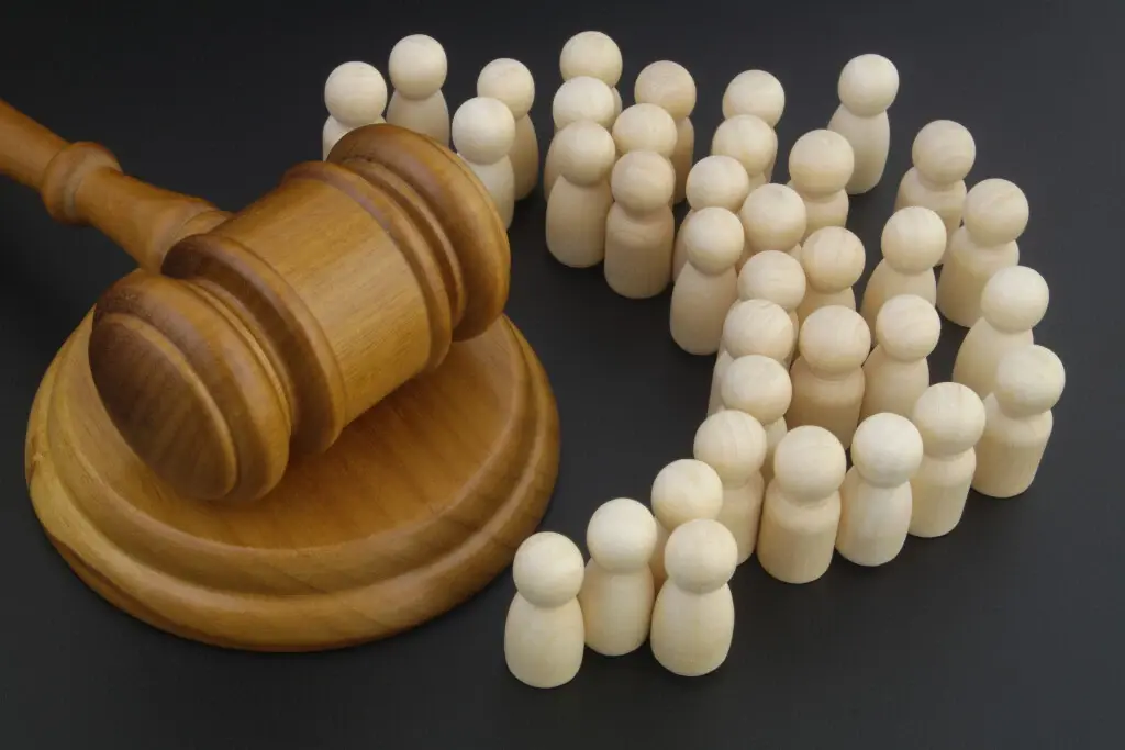 Pros and Cons of Joining a Class Action Lawsuit Gavel surrounded by white pieces