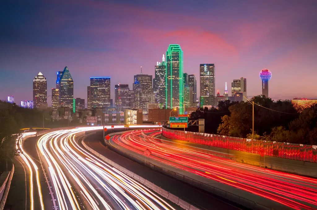 Texas car accident laws influencing a highway at night.