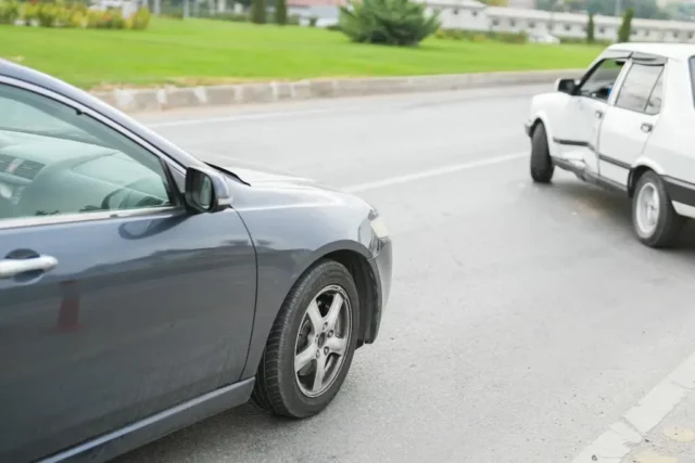 What causes a T-bone car accident? Two cars crashed on the side of a road.