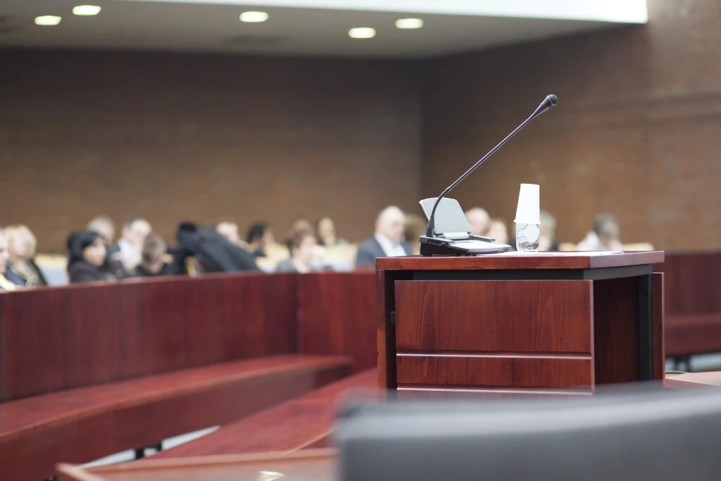 A microphone in a jury room, and a group of people applying for class certification.