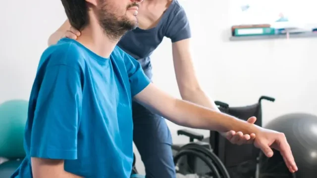 A disabled person undergoing physical therapy after a spinal cord injury