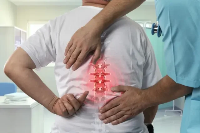 A man experiencing increased pain in the spine.