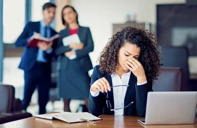 A woman experiencing disparaging remarks in the workplace.