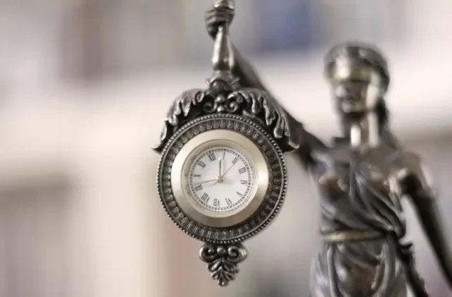 A law statute holding a clock, showing the statute of limitations in Arizona