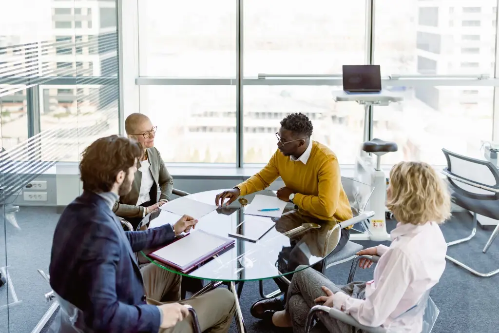 A table of co-workers discussing at-will employment states for their company.