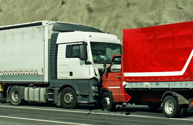 Two trucks colliding in a head-on accident.